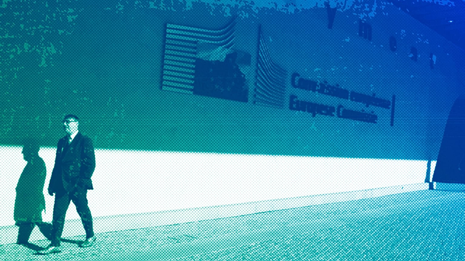 A man walks by the European Union logo outside EU headquarters in Brussels, February 2020