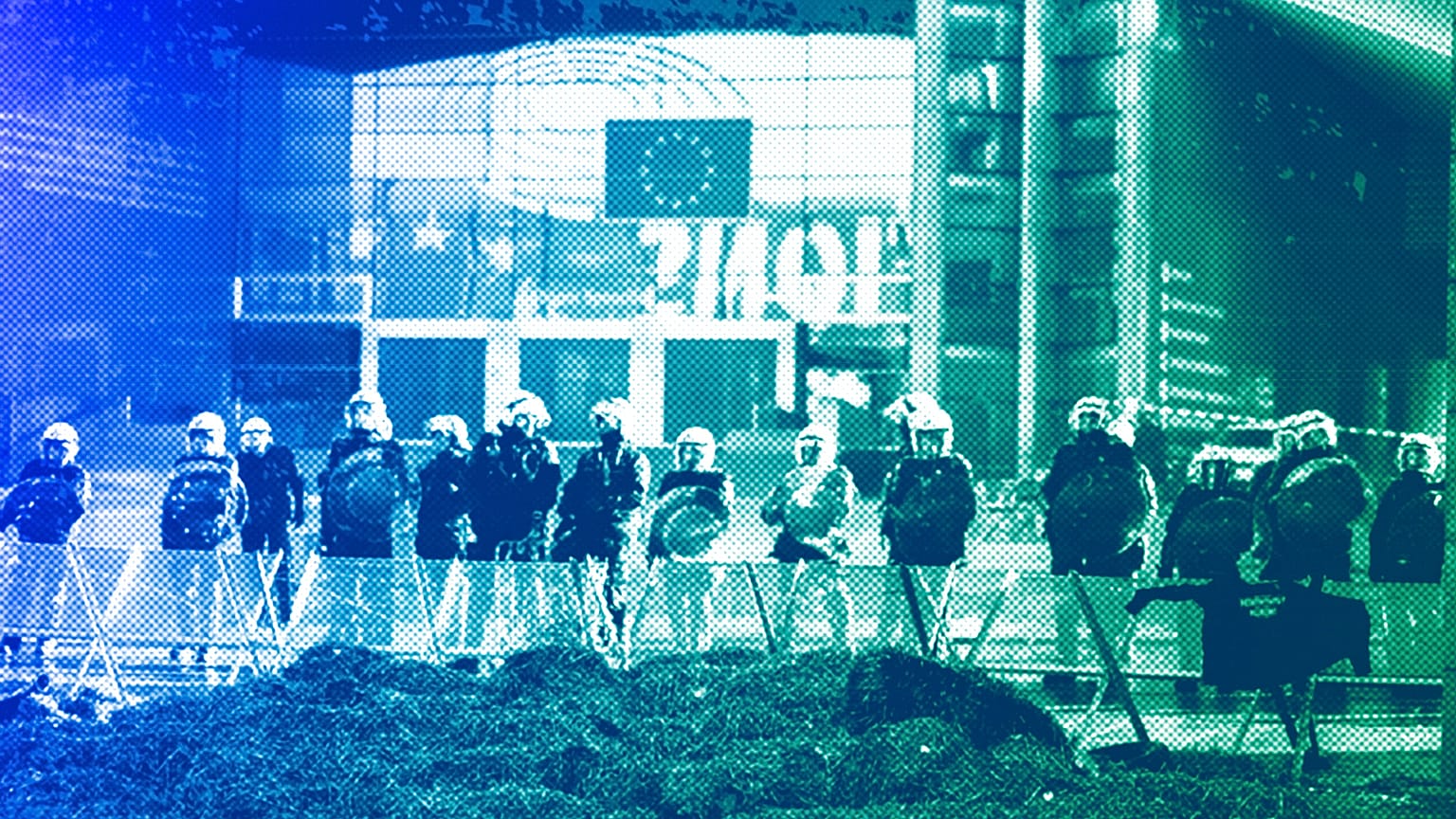 Anti riot police officers stand guard in a closed security area outside the European Parliament during a protest by farmers in Brussels, February 2024