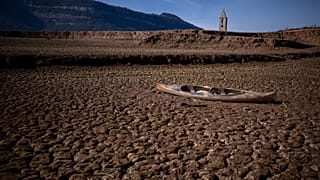 An abandoned canoe lies on the cracked ground at the Sau reservoir, which is only at 5 percent of its capacity, in Vilanova de Sau, about 100 km north of Barcelona