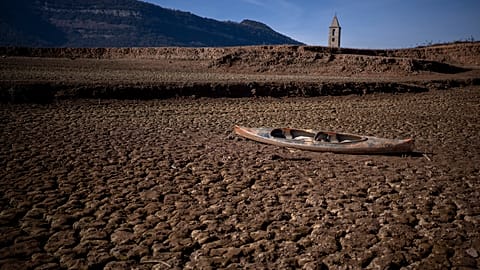An abandoned canoe lies on the cracked ground at the Sau reservoir, which is only at 5 percent of its capacity, in Vilanova de Sau, about 100 km north of Barcelona