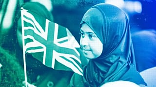 A girl waves a flag of the United Kingdom during a national Muslim memorial for the late Queen Elizabeth II at the central mosque in London, September 2022