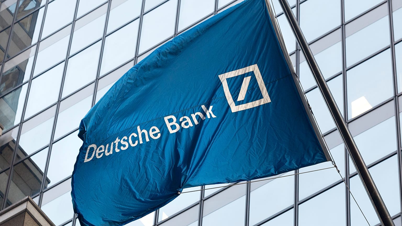A flag for Deutsche Bank flies outside the German bank's New York offices on Wall Street. Oct. 7, 2016.