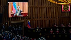 Venezuelan President Nicolas Maduro's live video image plays on monitors as he speaks during a ceremony marking the new judicial year at the Supreme Court in Caracas