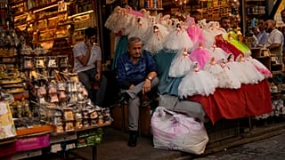 Sellers wait for clients in a street market in Istanbul, Turkey, Wednesday, Sept. 6, 2023. 