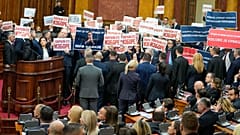 Opposition lawmakers hold banners reading: "Stole the elections" during a Serbia's parliament constitutive session in Belgrade, Serbia, Tuesday, Feb. 6, 2024