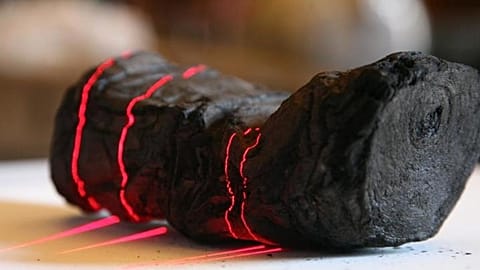 Herculaneum scroll with red laser lines being scanned at Institut de France by Brent Seales and his team