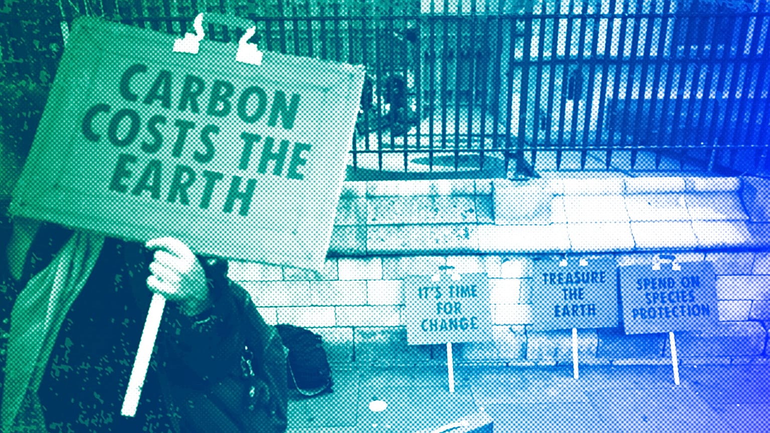 A woman holds a placard as she participates in a demonstration on the budget outside Parliament in London, March 2020