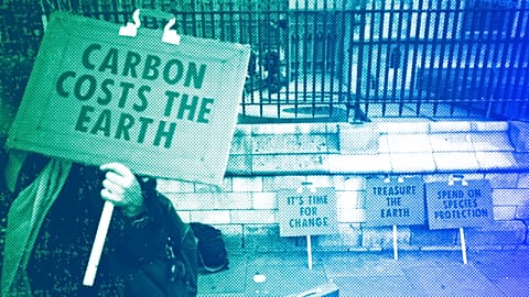 A woman holds a placard as she participates in a demonstration on the budget outside Parliament in London, March 2020