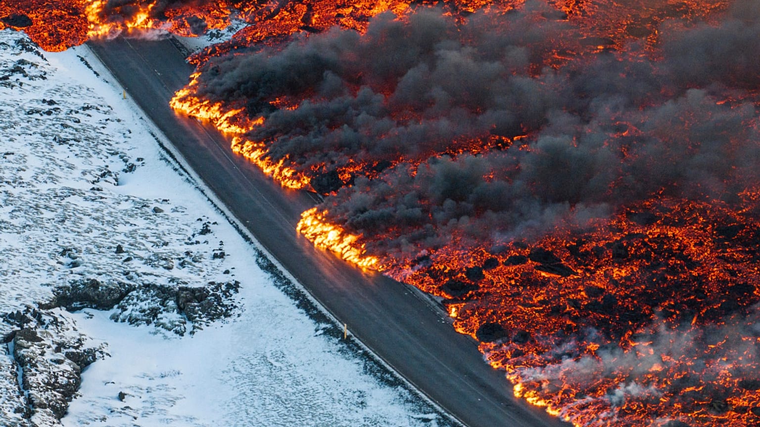 A view of lava crossing the main road to Grindavík and flowing on the road leading to the Blue Lagoon, in Grindavík, Iceland, Thursday, 8 Feb. 2024.