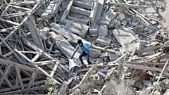 Palestinians walk through the destruction left by the Israeli air and ground offensive on the Gaza Strip in Gaza City, Saturday, Feb. 10, 2024. 