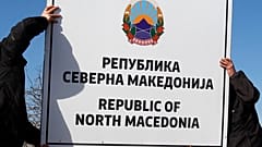 Workers install a new road sign with the name Republic of North Macedonia in the southern border with Greece, near Gevgelija, Wednesday, Feb. 13, 2019.