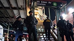 New York City Police officers stand guard following a shooting at the Mount Eden subway station, Monday, Feb. 12, 2024, in the Bronx borough of New York.