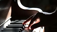A musician plays the piano
