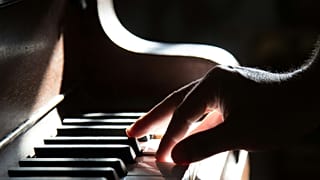 A musician plays the piano