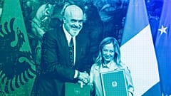 Italy's PM Giorgia Meloni and Albania's PM Edi Rama shake hands after the signing of a memorandum of understanding on migrant management centers, in Rome, November 2023