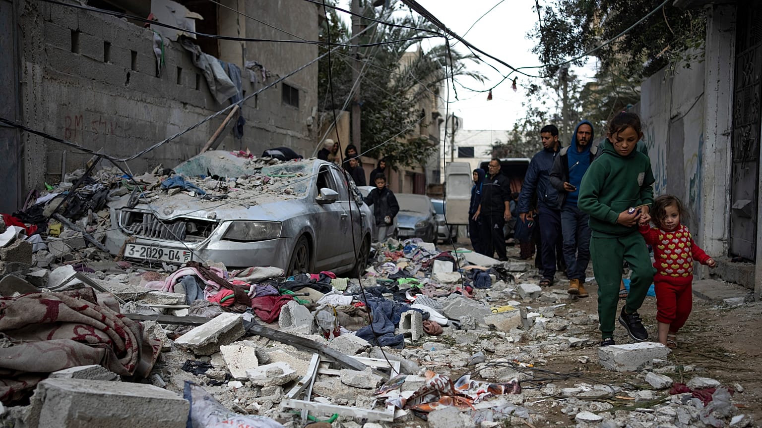 Palestinians look at the destruction after an Israeli airstrike in Rafah, Gaza Strip, Friday, Feb. 9, 2024. 