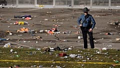 A law enforcement officer looks around the scene following a shooting at the Kansas City Chiefs NFL football Super Bowl celebration in Kansas City, Mo. 14/2/24.
