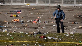 A law enforcement officer looks around the scene following a shooting at the Kansas City Chiefs NFL football Super Bowl celebration in Kansas City, Mo. 14/2/24.
