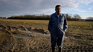 Bart Dochy stands in front of one of the fields at his family farm in Ledegem, Belgium.