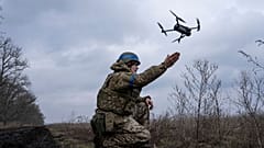 A Ukrainian serviceman of the 68 Oleksa Dovbush hunting brigade, launches a drone at the frontline near Vuhledar, Ukraine, Wednesday, Feb. 22, 2023. 