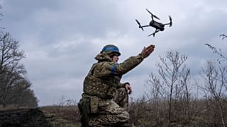A Ukrainian serviceman of the 68 Oleksa Dovbush hunting brigade, launches a drone at the frontline near Vuhledar, Ukraine, Wednesday, Feb. 22, 2023. 