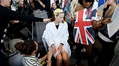 Models wear outfits by designer Bora Asku during his Spring/Summer 2015 show at London Fashion Week in London.