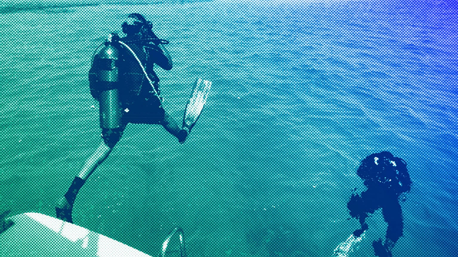 Two diving instructors explore the waters off a sandy island in the Red Sea near King Abdullah Economic City, Saudi Arabia, March 2018