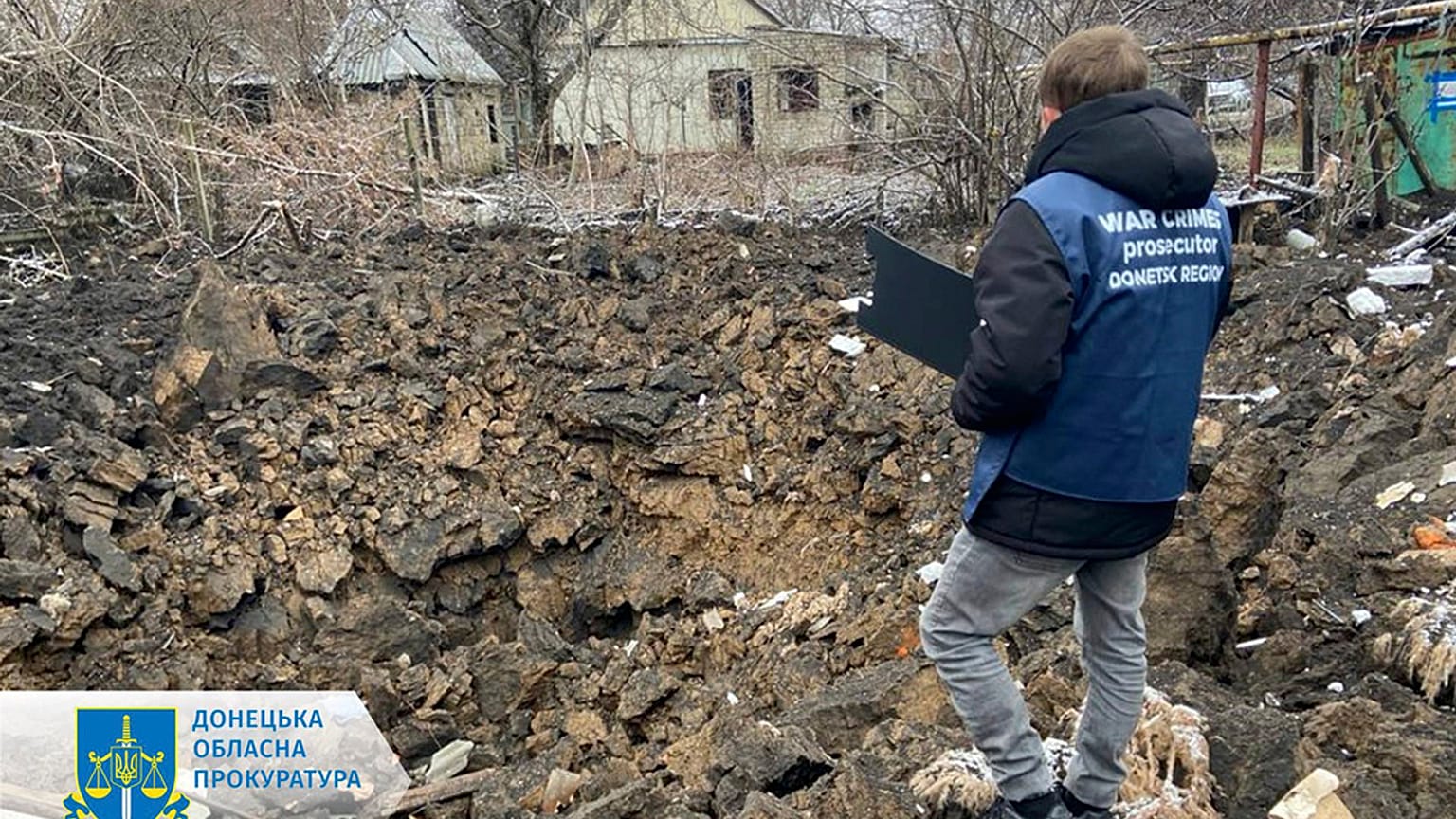 In this photo provided by the Donetsk Regional Prosecutor's Office, a war crime prosecutor inspects the scene after shelling in Pokrovsk, Ukraine, Thursday, Nov. 30, 2023.