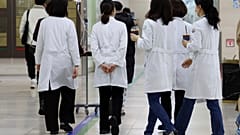 Medical workers walk inside a general hospital in Gwangju, South Korea.