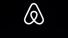 This Feb. 22, 2018, file photo shows an Airbnb logo during an event in San Francisco. 