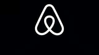 This Feb. 22, 2018, file photo shows an Airbnb logo during an event in San Francisco. 