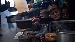 Palestinians line up for a free meal in Rafah, Gaza Strip, Friday, Feb. 16, 2024.