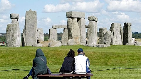 Tourists looking at The Stonehenge on Salisbury Plain in England. 