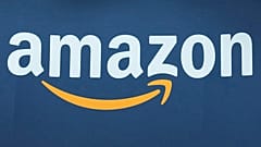 he Amazon logo is seen, June 15, 2023, at the Vivatech show in Paris. Amazon.com is being added to the Dow Jones Industrial Average, joining Apple, Walt Disney, Walmart and ot