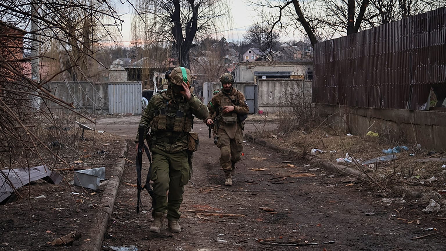 Ukrainian soldiers walk along a street in the area of the heaviest battles with the Russian invaders in Bakhmut, Donetsk region, Ukraine, Wednesday, 15 March, 2023. 