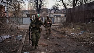 Ukrainian soldiers walk along a street in the area of the heaviest battles with the Russian invaders in Bakhmut, Donetsk region, Ukraine, Wednesday, 15 March, 2023. 