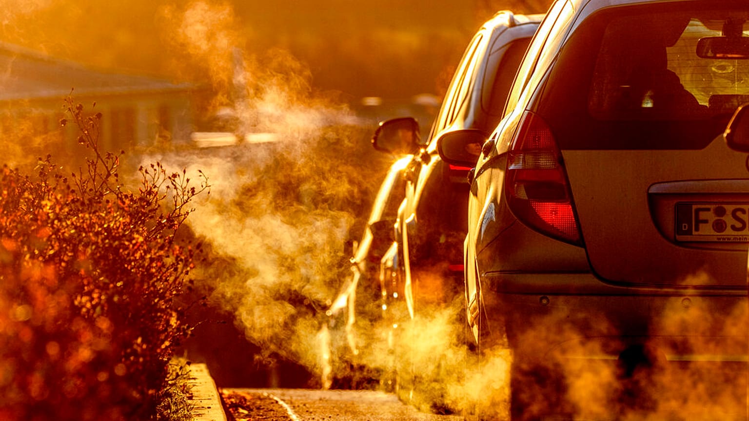 Pollution rises from car exhausts driving on a road in a residential area in Frankfurt, Germany, early Monday, Feb. 27, 2023