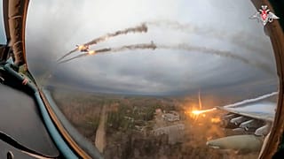 A Russian Su-25 warplane is seen from the cockpit of another such aircraft as they fire rockets on a mission over Ukraine.