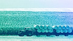  A tractor with trailers transports bales of straw from a field near Dachau, August 2009
