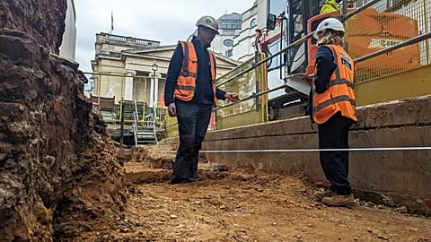 Archaeologists discuss the final bit of planning of the excavation at the National Gallery's Jubilee Walk.
