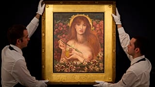 Sotheby's auction house employees pose for photographs with the Dante Gabriel Rossetti watercolor "Venus Verticordia" at their premises in London, Friday, Dec. 5, 2014.