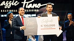 Andrey Gugnin receiving a €100,000 cheque at the final of the Classic Piano International Competition.