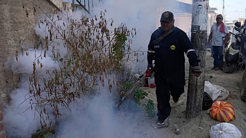A health worker fumigates for mosquitoes to help mitigate the spread of dengue, outside a home at La Primavera shantytown in Piura, Peru, June 3, 2023.