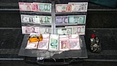 Current and pre-revolution Iranian banknotes and foreign currencies are displayed by a vendor at a commercial district in downtown Tehran, Iran, Friday, Dec. 23, 2022.