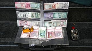 Current and pre-revolution Iranian banknotes and foreign currencies are displayed by a vendor at a commercial district in downtown Tehran, Iran, Friday, Dec. 23, 2022.