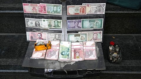 Current and pre-revolution Iranian banknotes and foreign currencies are displayed by a vendor at a commercial district in downtown Tehran, Iran, Friday, Dec. 23, 2022.