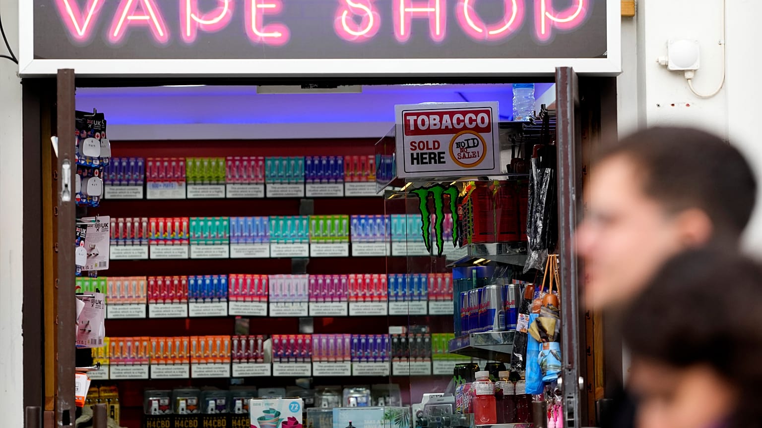 Pedestrians pass a vape shop in London, Monday, January 29, 2024.