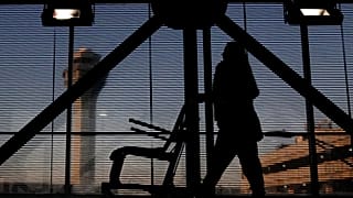 An airline employee transfers a wheelchair to her station at O'Hare International Airport in Chicago, Nov. 23, 2022.
