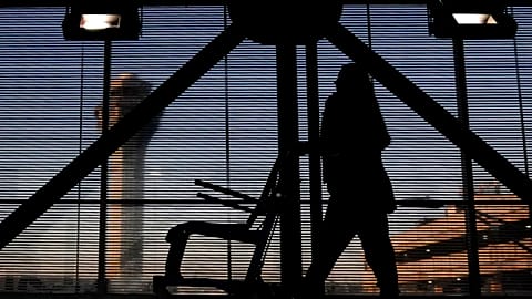 An airline employee transfers a wheelchair to her station at O'Hare International Airport in Chicago, Nov. 23, 2022. 