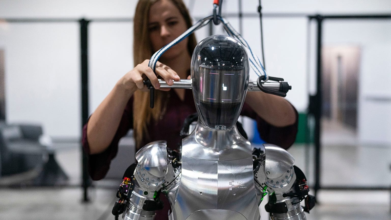 AI engineer Jenna Reher works on humanoid robot Figure 01 at Figure AI's test facility.
